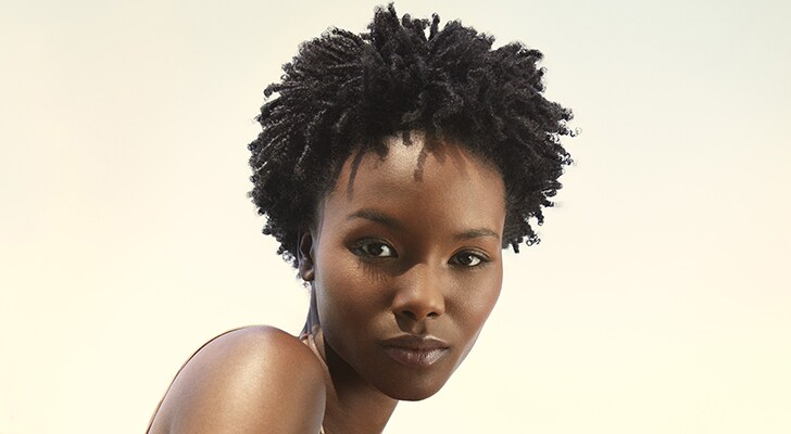two models with dark naturally curly and coily hair